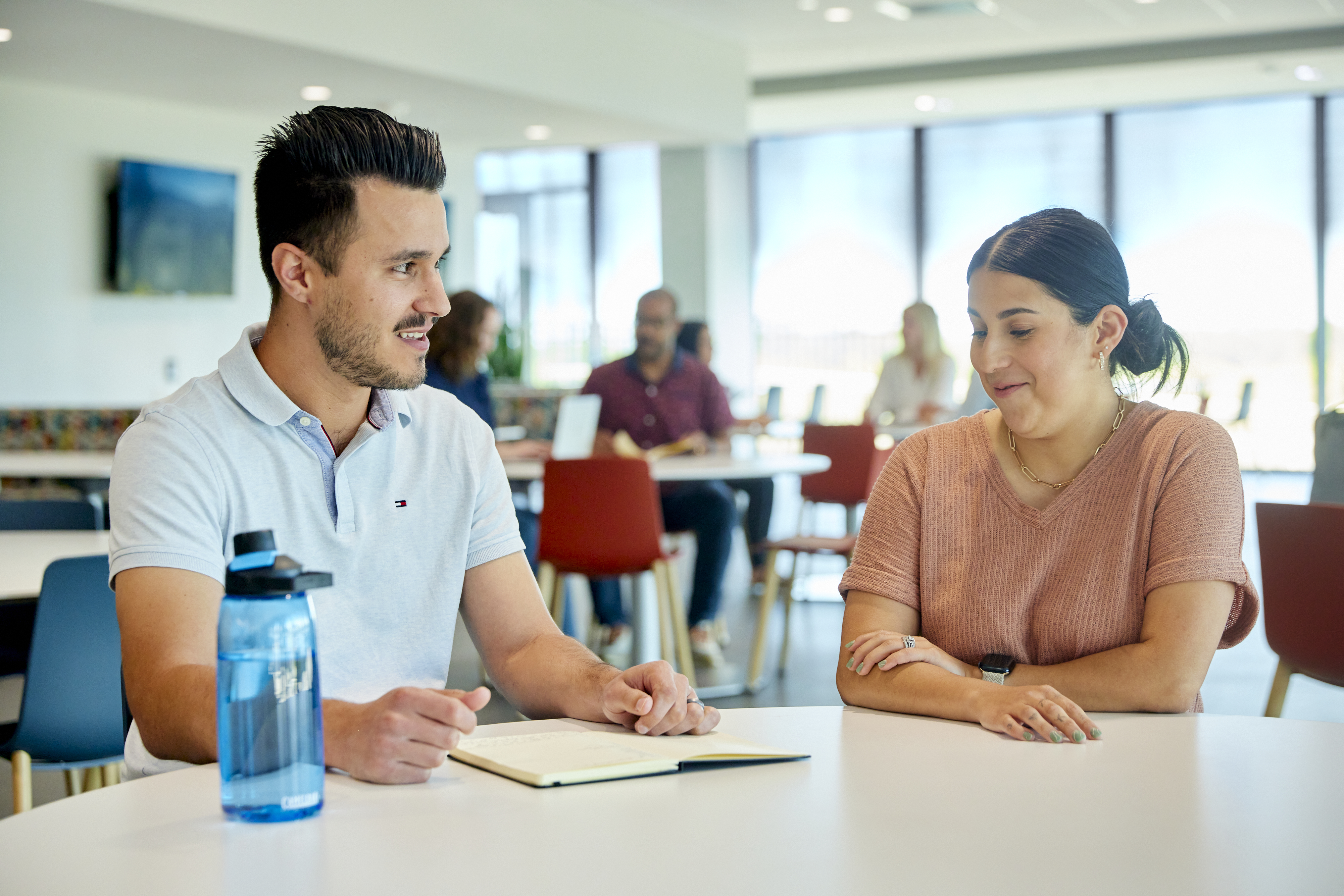 Employees sitting together at a table in the cafe